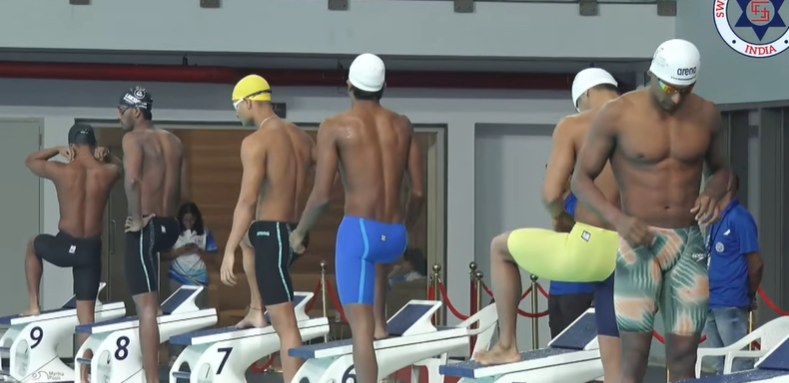 Swimmers behind the starting blocks in Ahmedabad